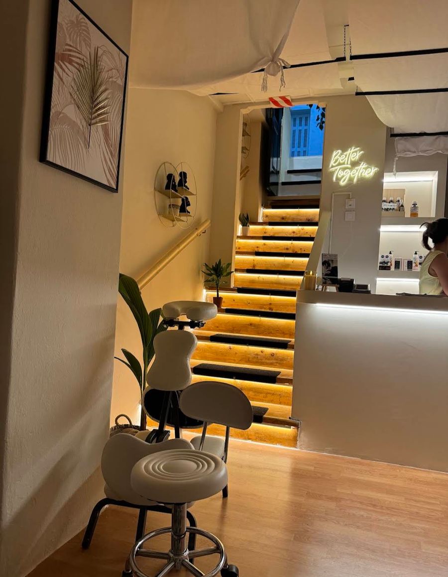 Illuminated wooden staircase and Better Together neon sign at Enyo couples Thai massage in Athens